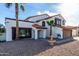 Charming two-story home with a fountain, red tile roof, and desert landscape in the front yard at 5761 E Tierra Buena Ln, Scottsdale, AZ 85254