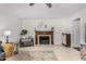 Bright living room featuring a fireplace, ceiling fan and neutral color palette with tile flooring at 5761 E Tierra Buena Ln, Scottsdale, AZ 85254