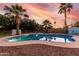 Enjoy this beautiful backyard pool surrounded by lush greenery and lounge chairs for relaxation at 5761 E Tierra Buena Ln, Scottsdale, AZ 85254