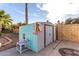 Backyard shed providing extra storage and a fun pop of color to the landscape at 5761 E Tierra Buena Ln, Scottsdale, AZ 85254