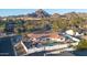 Captivating aerial view of a sprawling home, sparkling pool, manicured landscaping, and majestic mountain views at 5801 N 22Nd Pl, Phoenix, AZ 85016