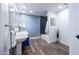 Bright bathroom featuring blue patterned wallpaper, a soaking tub, and modern fixtures at 5801 N 22Nd Pl, Phoenix, AZ 85016