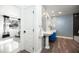 Bright bathroom with stylish blue patterned wallpaper and a modern pedestal sink and faucet at 5801 N 22Nd Pl, Phoenix, AZ 85016