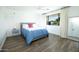 Light-filled bedroom featuring wood floors, a large window, and stylish decor at 5801 N 22Nd Pl, Phoenix, AZ 85016