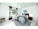 Bright bedroom featuring a stylish rug, white ceiling fan, and modern black and white curtains at 5801 N 22Nd Pl, Phoenix, AZ 85016