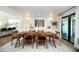 Bright dining room with modern lighting, wood table and chairs, and sliding doors to the outside at 5801 N 22Nd Pl, Phoenix, AZ 85016