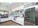 Well-equipped white kitchen featuring stainless steel appliances, sleek cabinetry, and a convenient layout at 5801 N 22Nd Pl, Phoenix, AZ 85016