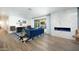 Modern living room featuring a comfortable blue sofa, an electric fireplace and a beautiful blue patterned rug at 5801 N 22Nd Pl, Phoenix, AZ 85016