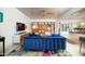 Spacious living room featuring a blue sofa, modern shelving, and an open layout into other rooms at 5801 N 22Nd Pl, Phoenix, AZ 85016