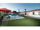 Inviting backyard featuring a sparkling pool, lush turf, and covered patio at 5801 N 22Nd Pl, Phoenix, AZ 85016