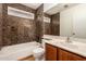 Cozy bathroom with a decorative mirror, vanity, bathtub, and toilet at 5808 E Brown Rd # 110, Mesa, AZ 85205