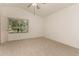 Spacious bedroom with plush carpeting, ceiling fan, and sunlit window with views at 5808 E Brown Rd # 110, Mesa, AZ 85205