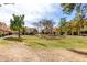 View of residential townhomes with grassy common area and mature trees at 5808 E Brown Rd # 110, Mesa, AZ 85205