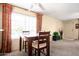 Bright dining space with a wooden table set, big window, and neutral walls at 5808 E Brown Rd # 110, Mesa, AZ 85205