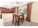 Cozy dining area with wood table set and natural light from the window at 5808 E Brown Rd # 110, Mesa, AZ 85205