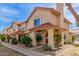 Quaint townhouse featuring a red tile roof, cozy porch, and desert-friendly landscaping at 5808 E Brown Rd # 110, Mesa, AZ 85205