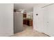 Open kitchen with stainless steel refrigerator, modern appliances, and tile flooring at 5808 E Brown Rd # 110, Mesa, AZ 85205