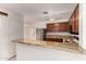 Kitchen with granite countertop, offering an open view and stainless steel refrigerator at 5808 E Brown Rd # 110, Mesa, AZ 85205