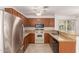 Full kitchen view with stainless steel appliances, granite countertops, and tile floors at 5808 E Brown Rd # 110, Mesa, AZ 85205