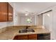 Kitchen sink with granite countertops, cabinets, and an open view to the living room at 5808 E Brown Rd # 110, Mesa, AZ 85205
