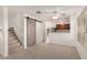 Inviting living area with a barn door accent and seamless transition to the well-equipped kitchen at 5808 E Brown Rd # 110, Mesa, AZ 85205