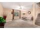 Inviting living room with plush carpet, a modern fan, and ample natural light at 5808 E Brown Rd # 110, Mesa, AZ 85205