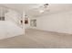 Open living space with staircase, large window, and seamless flow to the kitchen at 5808 E Brown Rd # 110, Mesa, AZ 85205