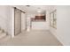 Open-concept living room with stylish barn door and convenient access to the kitchen at 5808 E Brown Rd # 110, Mesa, AZ 85205