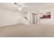 Spacious living room with neutral carpet, ceiling fans and staircase access to upper level at 5808 E Brown Rd # 110, Mesa, AZ 85205