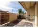 Private outdoor patio with textured concrete, stylish rug, secure fence, and a bicycle at 5808 E Brown Rd # 110, Mesa, AZ 85205