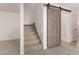 Carpeted staircase with decorative barn door and white railing for a contemporary design at 5808 E Brown Rd # 110, Mesa, AZ 85205