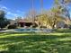 Expansive backyard with a refreshing pool, well-maintained lawn, and mature landscaping at 6242 E Maverick Rd, Paradise Valley, AZ 85253