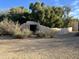 Charming walled entry to the property with mature trees and desert landscaping at 6242 E Maverick Rd, Paradise Valley, AZ 85253