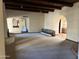 Open floor plan with fireplace, wood beam ceilings, and tile accents in the archways at 6242 E Maverick Rd, Paradise Valley, AZ 85253