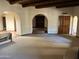 Spacious open living room with carpet and arched doorways, providing a seamless flow at 6242 E Maverick Rd, Paradise Valley, AZ 85253