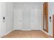 Bright hallway with laminate floors and multiple doors at 6605 N 93Rd Ave # 1024, Glendale, AZ 85305