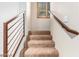 Carpeted staircase with modern railing and natural light at 6605 N 93Rd Ave # 1024, Glendale, AZ 85305