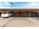 Community carport parking with assigned parking and brick privacy walls at 6812 N 35Th Ave # G, Phoenix, AZ 85017