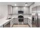 Well-lit kitchen featuring stainless steel appliances and modern gray cabinetry at 6812 N 35Th Ave # G, Phoenix, AZ 85017