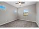 Neutral bedroom with two windows, ceiling fan, and gray carpet at 7057 E Diamond St, Scottsdale, AZ 85257