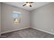 Neutral bedroom with a window, ceiling fan, and gray carpet at 7057 E Diamond St, Scottsdale, AZ 85257