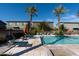 Relaxing community pool area with lounge seating and manicured landscaping near residential buildings at 7057 E Diamond St, Scottsdale, AZ 85257