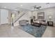 Open-concept living room with neutral tones, large windows, and a staircase at 7057 E Diamond St, Scottsdale, AZ 85257