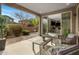 Covered patio seating area with sliding glass door into the kitchen and view to landscape at 7057 E Diamond St, Scottsdale, AZ 85257