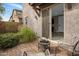 Charming outdoor patio seating area with views into home and lush landscaping around the perimeter at 7057 E Diamond St, Scottsdale, AZ 85257