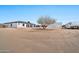 Large backyard featuring the home and garage, offering potential for various outdoor activities and customizations at 711 W Paso Nuevo Dr, Phoenix, AZ 85086