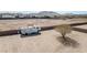 Wide-angle of an empty lot with a parked RV and fencing near desert homes at 711 W Paso Nuevo Dr, Phoenix, AZ 85086