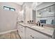 Bathroom vanity with stone counters, white cabinets, with black faucet and fixtures at 711 W Paso Nuevo Dr, Phoenix, AZ 85086