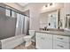 Bathroom with a shower, granite counters, white cabinets, black fixtures, and tile flooring at 711 W Paso Nuevo Dr, Phoenix, AZ 85086