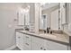 Modern bathroom with dual sinks, gray countertops and white cabinetry, providing ample storage at 711 W Paso Nuevo Dr, Phoenix, AZ 85086